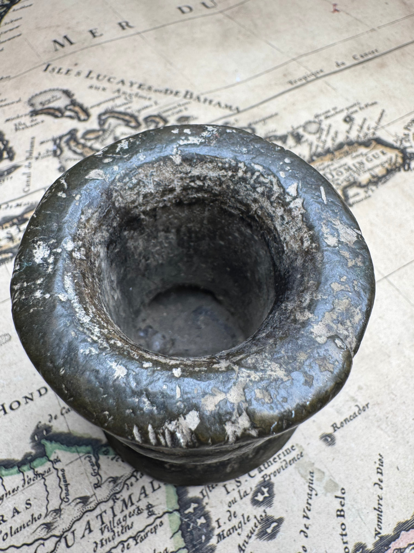 Top view down the bore of the bronze thunder mug with mineral deposits