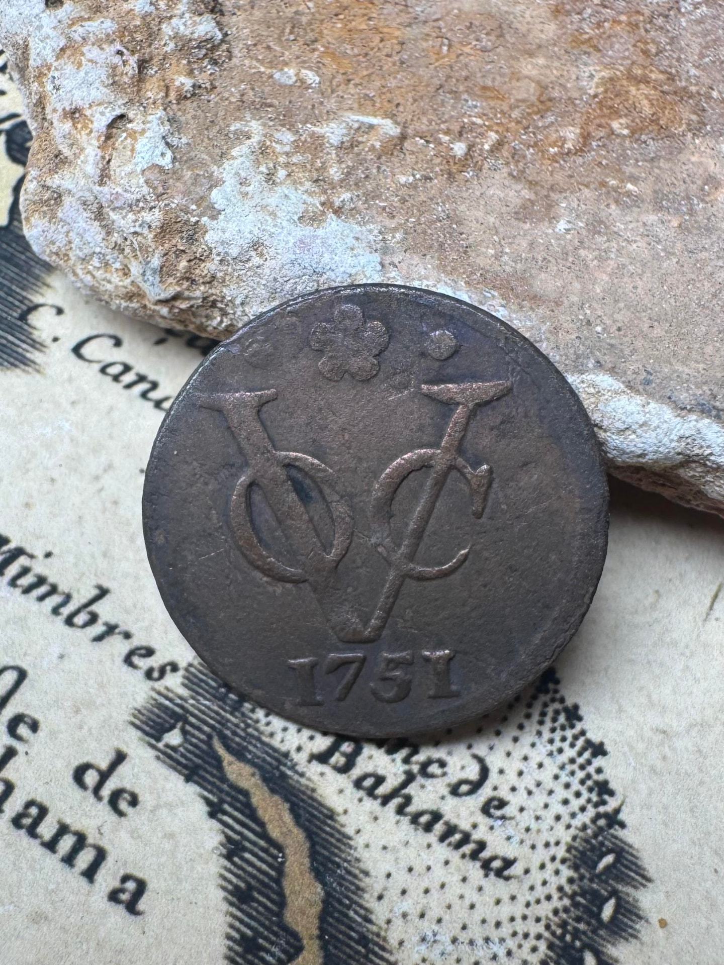 Dutch East India Company VOC monogram coin dated 1751 on an antique chart