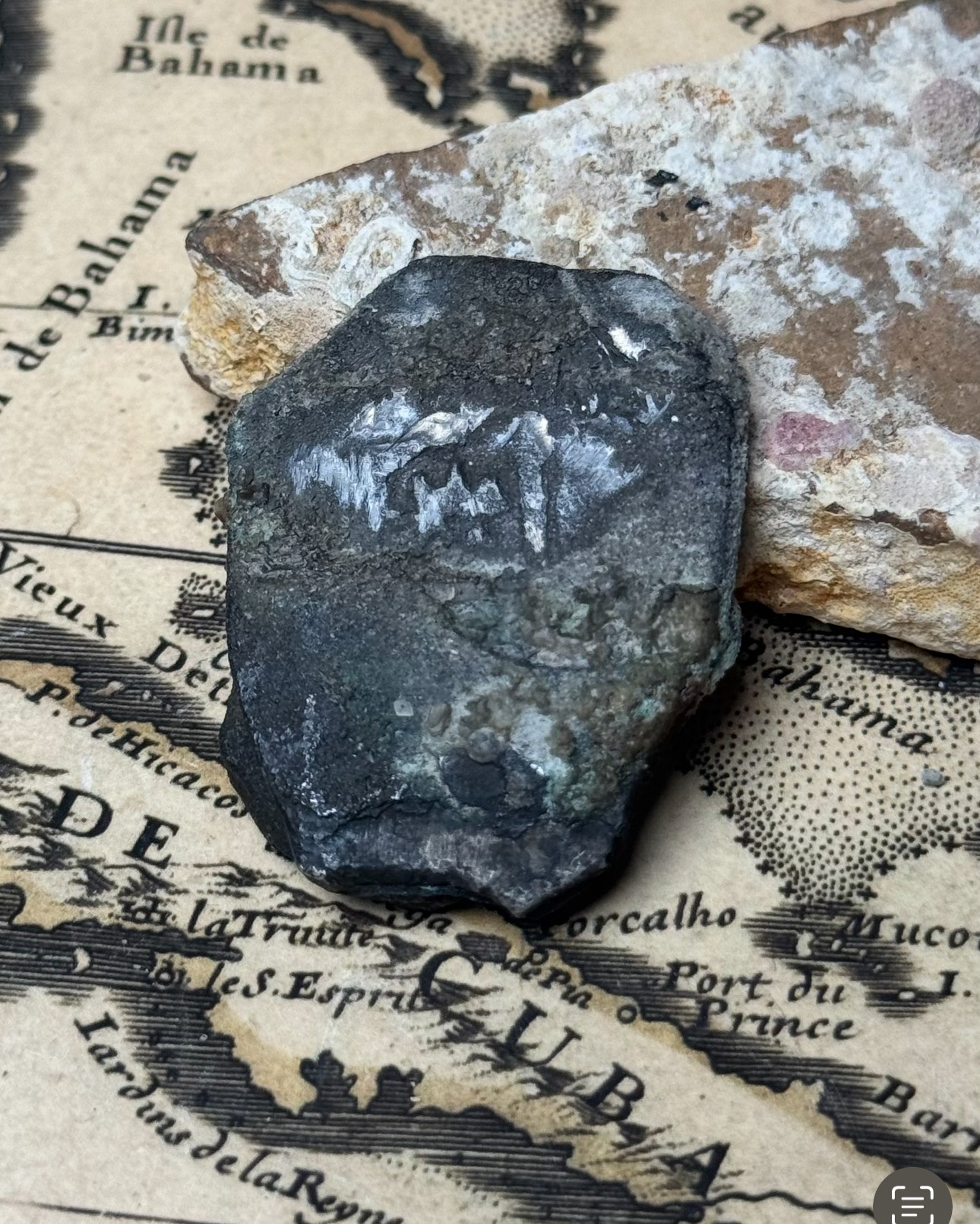 Encrusted 8 reales cob face of the 1715 Fleet two-coin clump