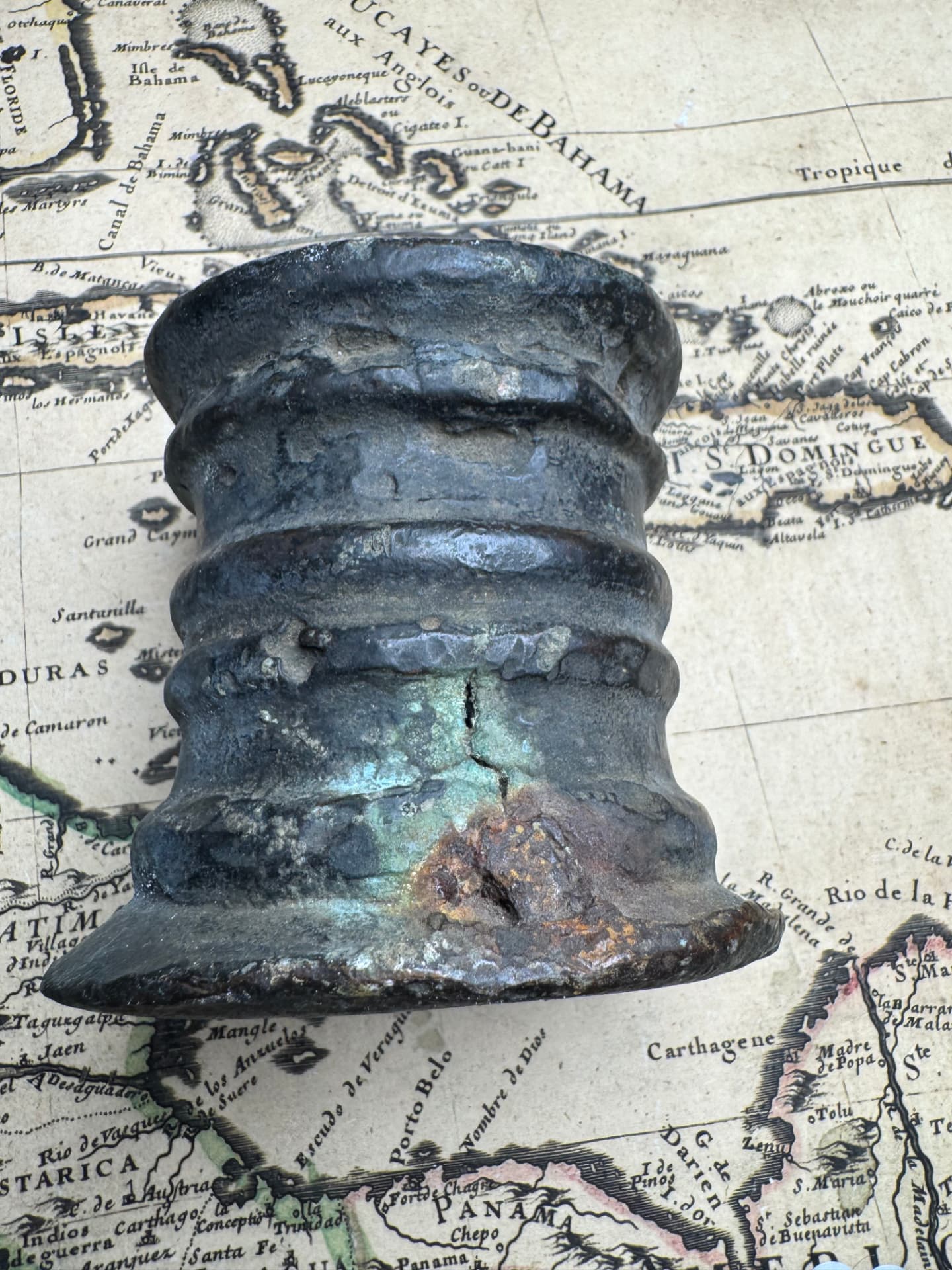 Side view of the bronze thunder mug showing green oxidation and mineralization