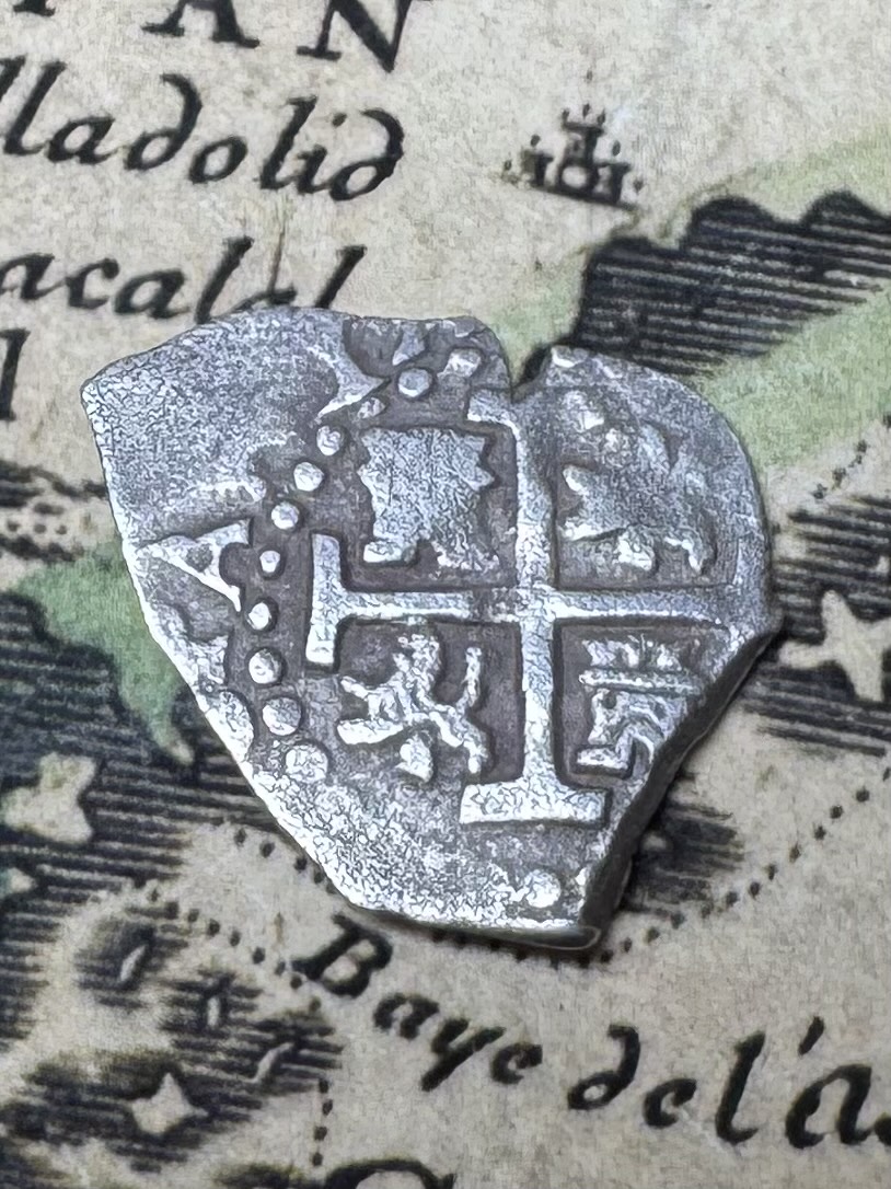 Spanish colonial 1/2 reale silver cob showing the cross side