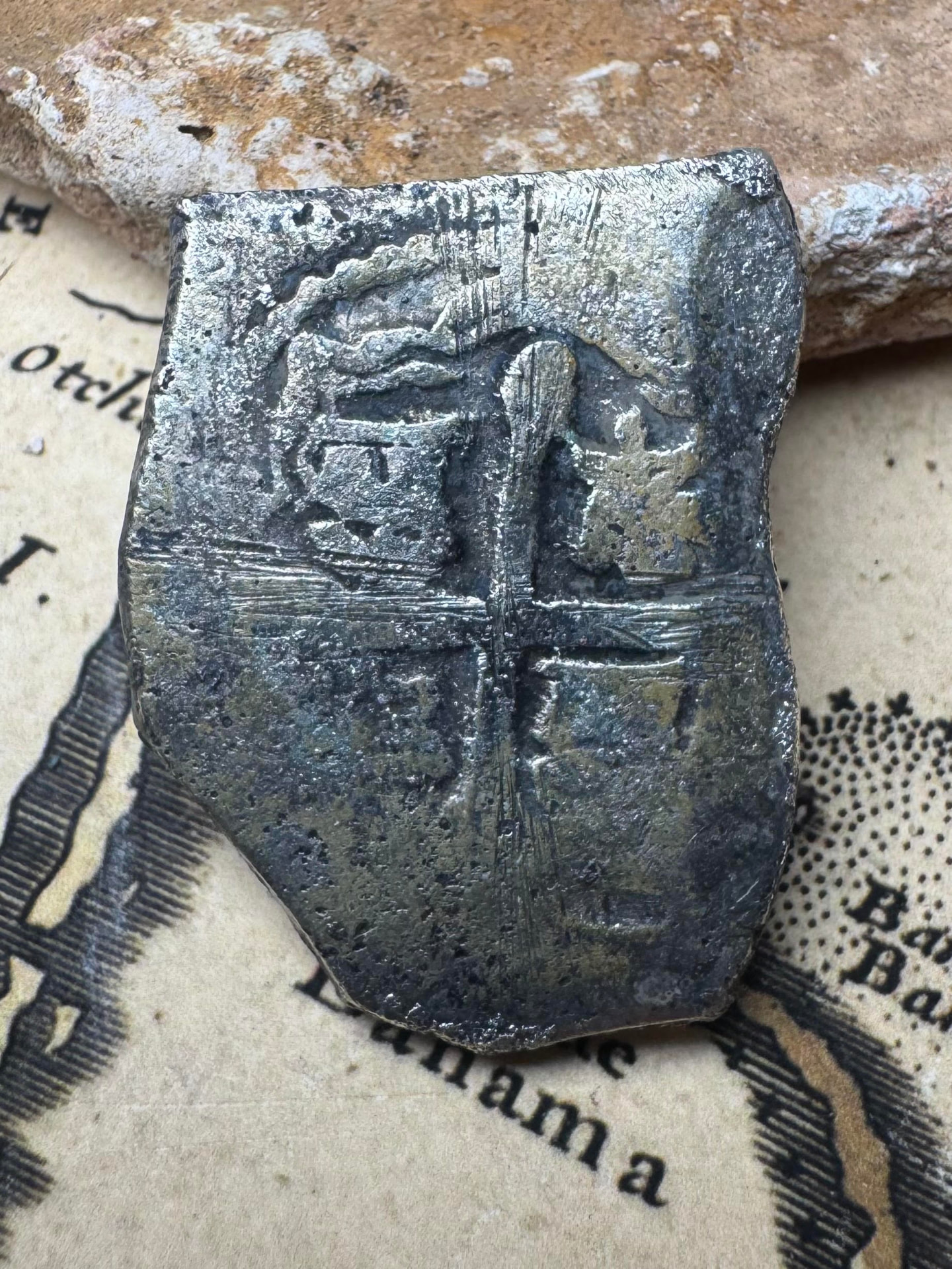 Cross side of the 1715 Fleet 4 reales silver cob with period scratches